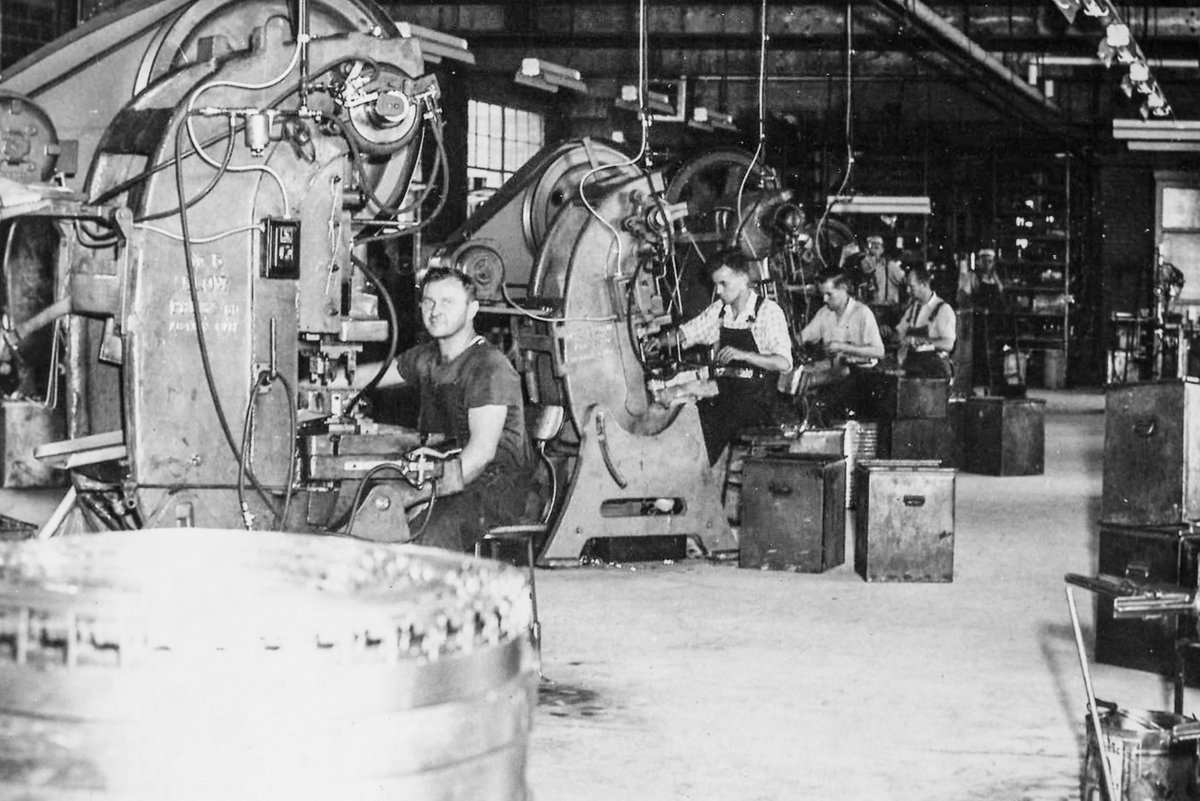 Toolmaking experts working on mechanical stamping presses in the original Globe Stamping factory.